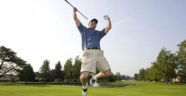 golfer jumping up in the air in excitement